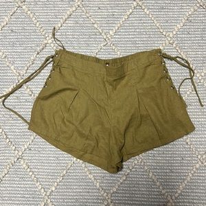 Army green shorts with silver accents on side